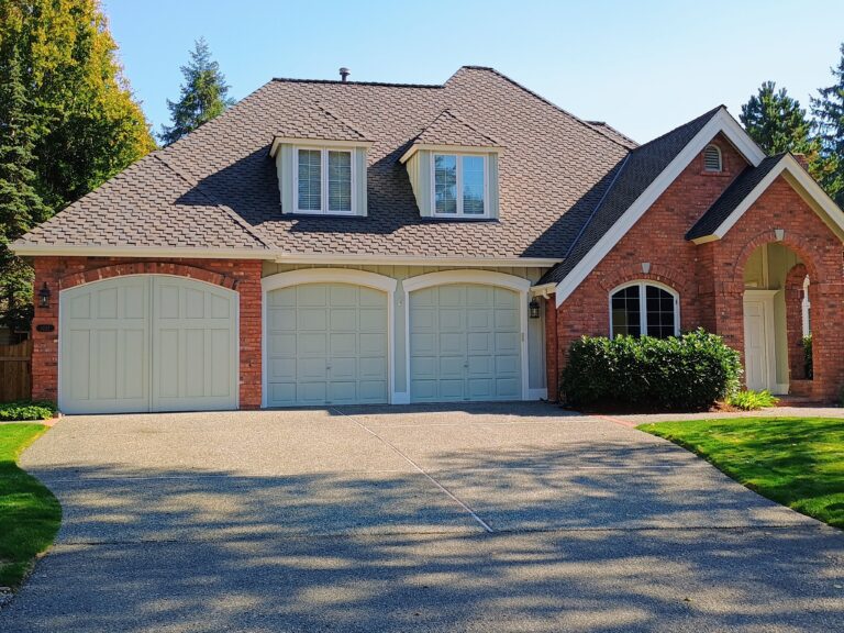 Brick house with a composition roof by B&J Roofing